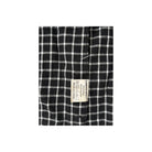 Black and white checkered fabric with a label on a white background