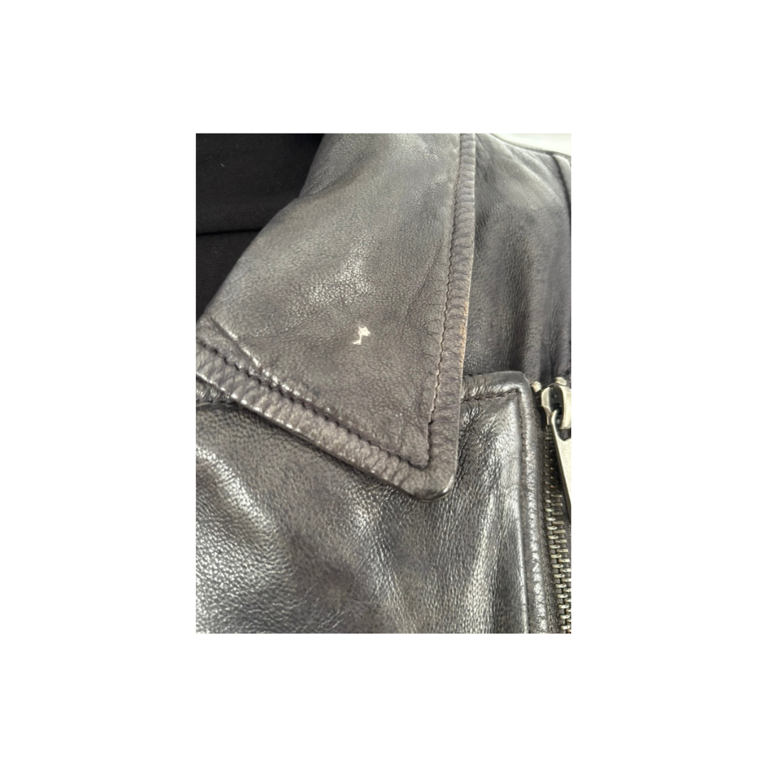 Close-up of a silver metallic jacket with a zipper