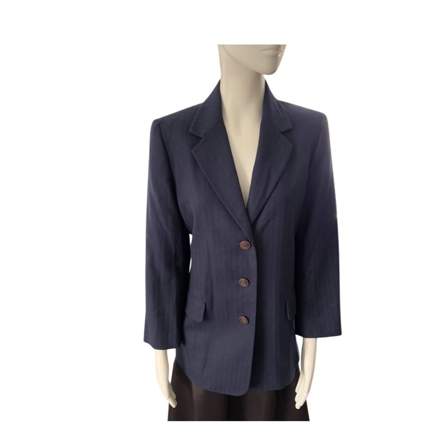 Navy blazer on a mannequin against a white background