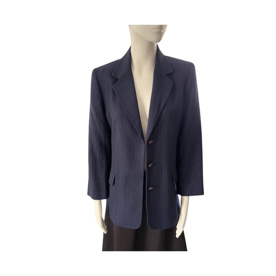Navy blue blazer on a mannequin against a white background