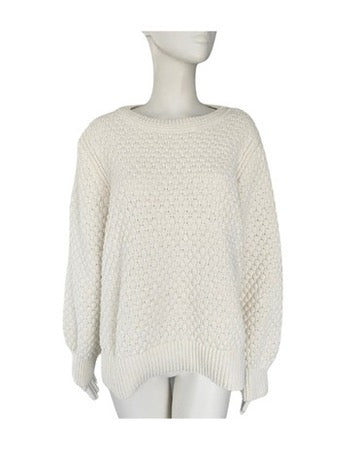 White textured sweater on a mannequin against a white background