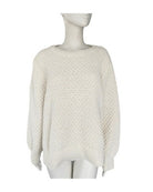 White textured sweater on a mannequin against a white background