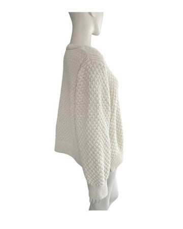 Cream knitted jumper on a mannequin against a white background