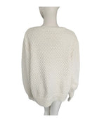 Cream textured sweater on a mannequin against a white background