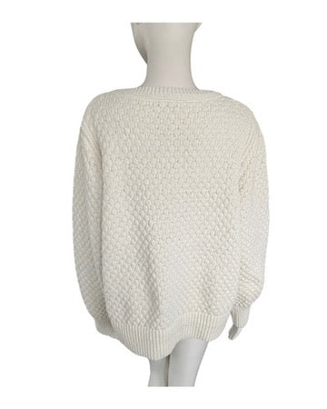 Cream textured sweater on a mannequin against a white background