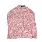 Pink blouse with white floral pattern on a white background