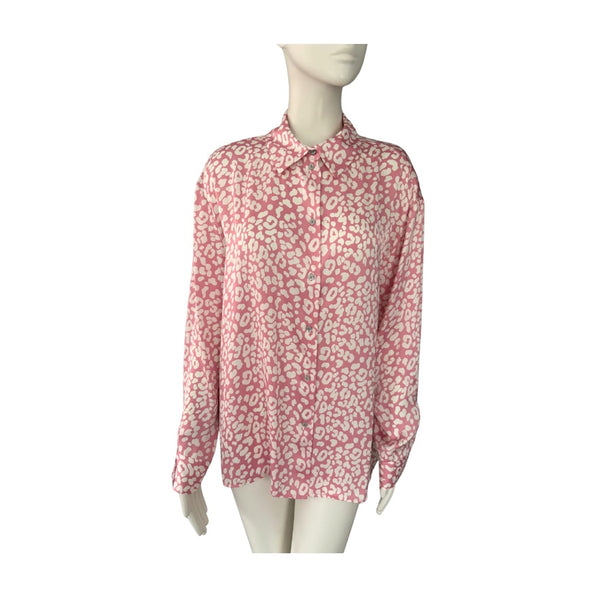 Pink leopard blouse on a mannequin against a white background