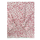 Pink shirt with white leopard print pattern on a white background