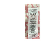Fabric label with washing instructions and material details on a pink floral background