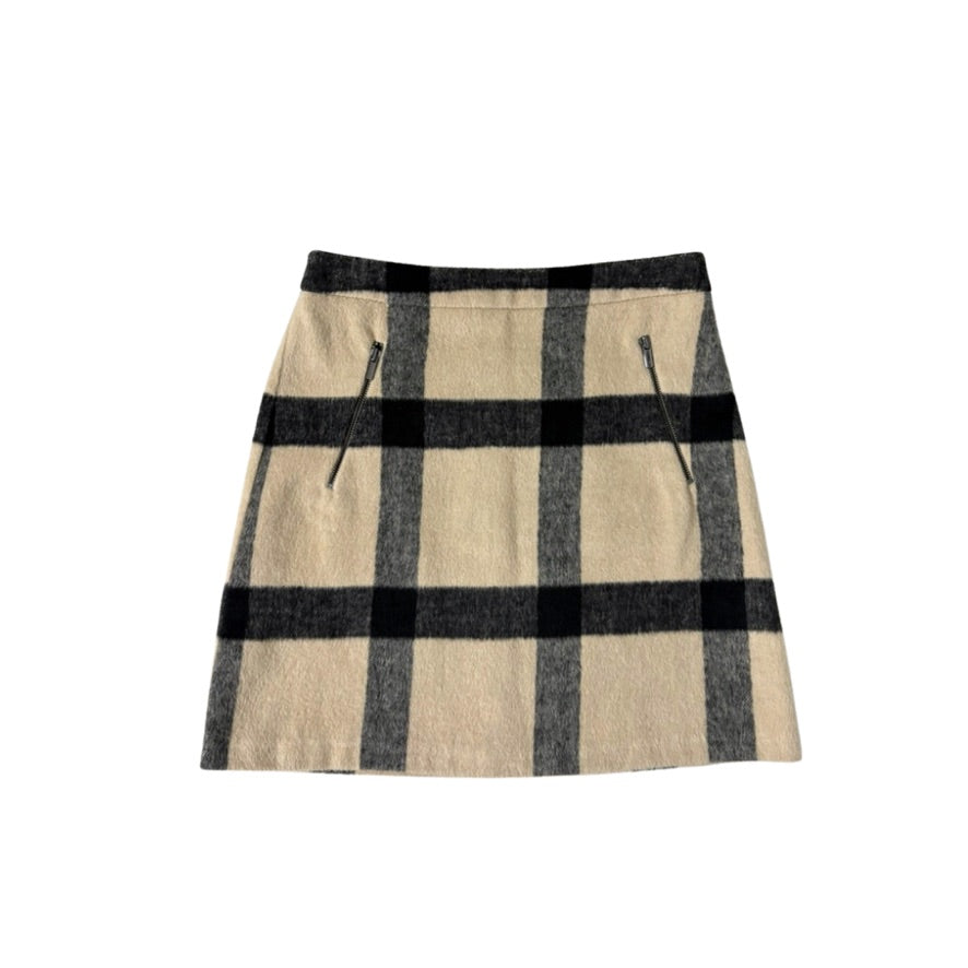 Plaid skirt with beige and black check pattern on a white background