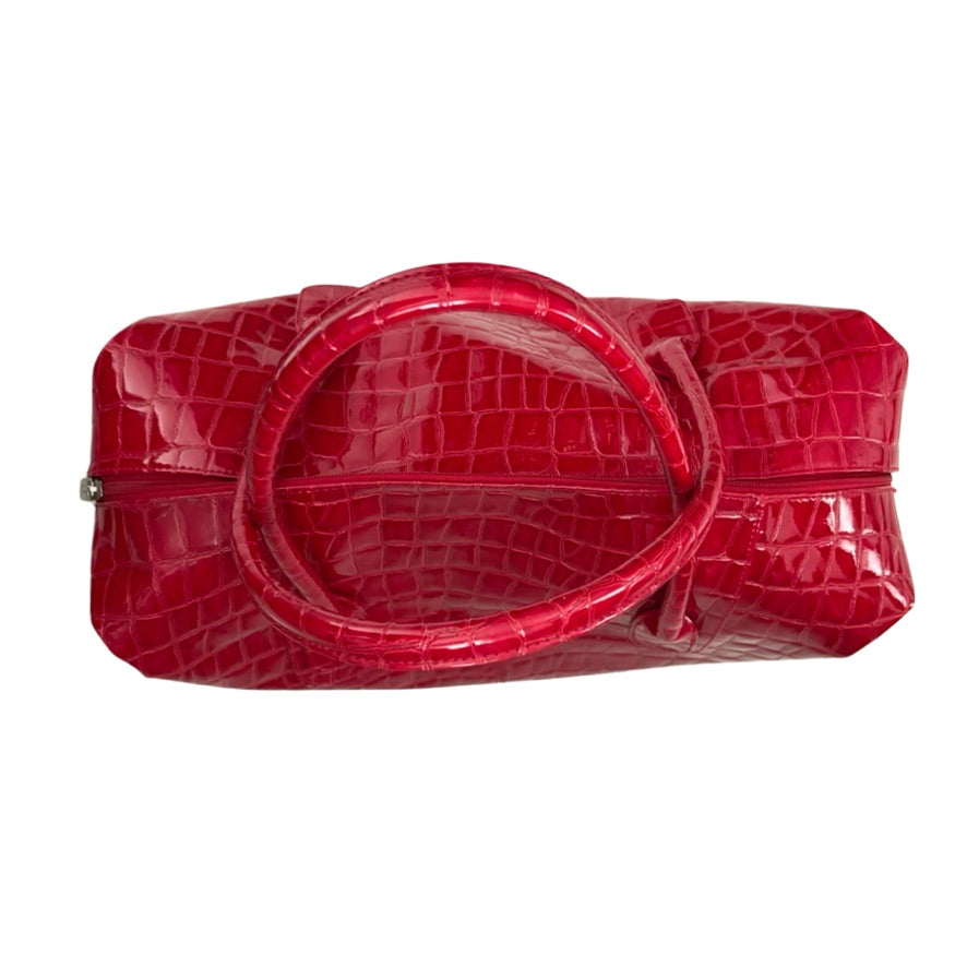 Red crocodile-patterned handbag on a white background