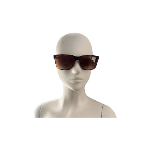 Mannequin head wearing brown sunglasses on a white background