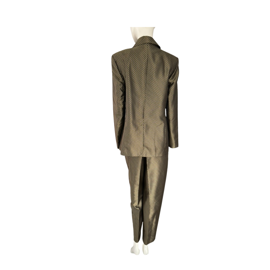 Gold suit on a mannequin against a white background