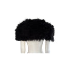 Black fur shawl on a white mannequin head against a white background