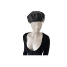 Mannequin head wearing a black beret on a white background