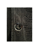 Close-up of a textured black surface with a metallic button.