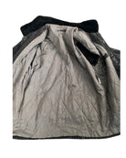 Quilted jacket with black trim on a white background