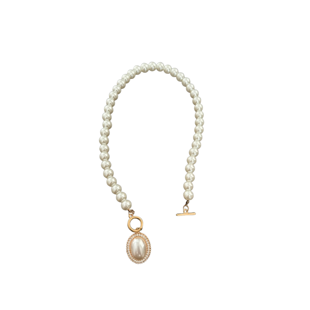 Pearl necklace with a gold pendant on a white background