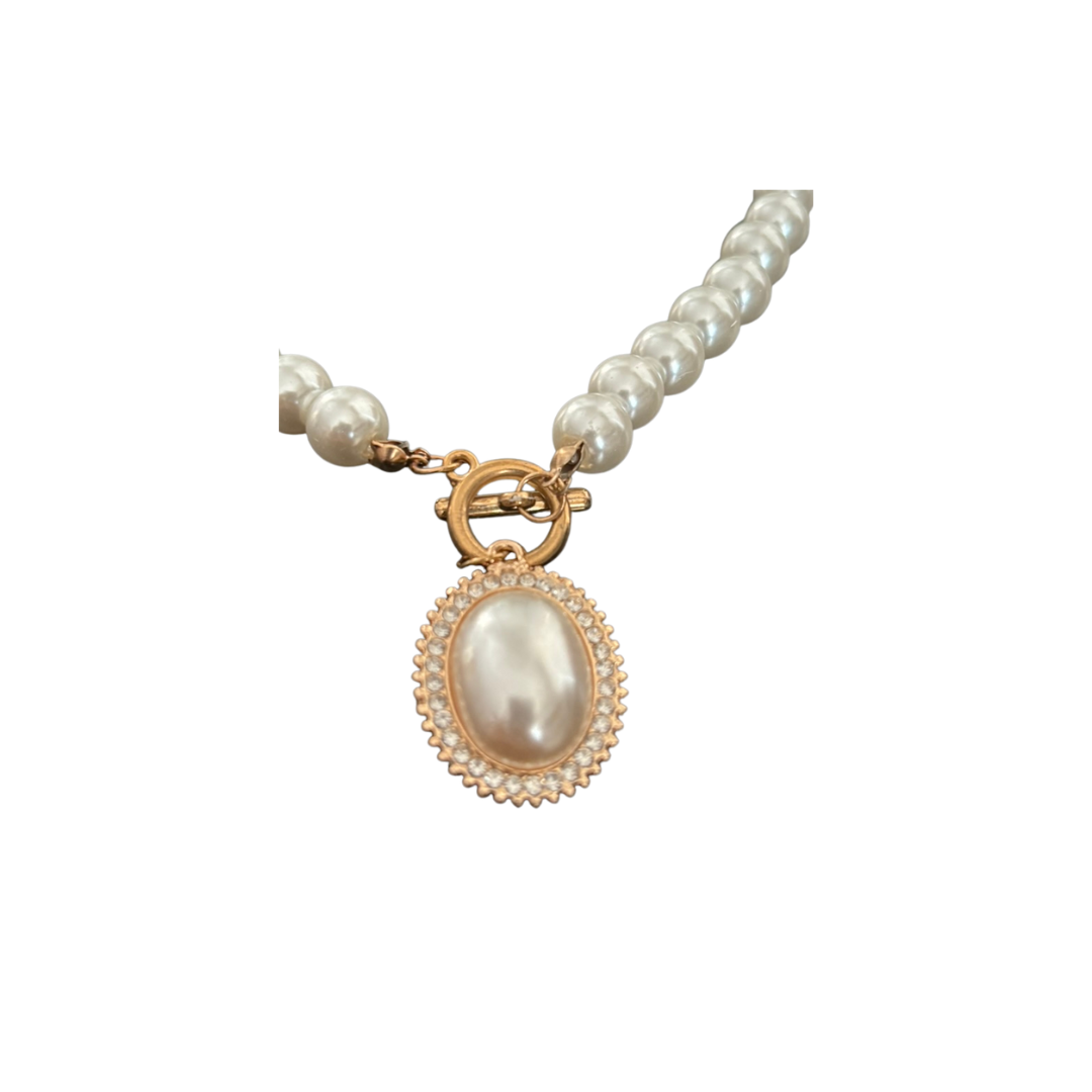 Pearl necklace with a gold clasp on a white background