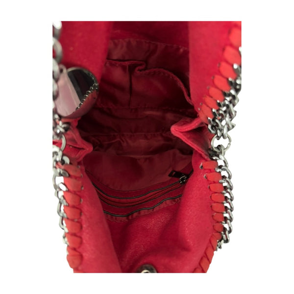 Close-up of a red handbag with chain details on a white background