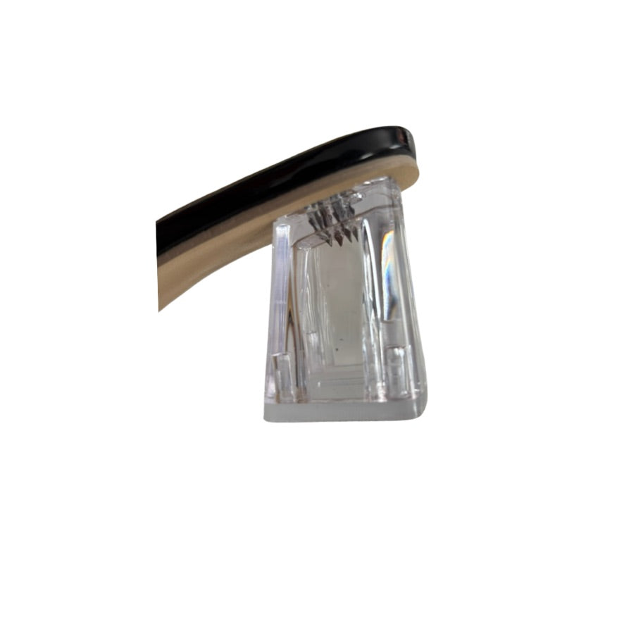 Close-up of a shoe with a clear crystal on a white background