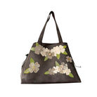 Floral-patterned handbag on a white background