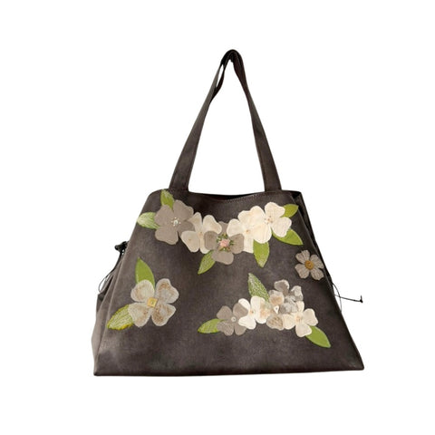Floral-patterned handbag on a white background