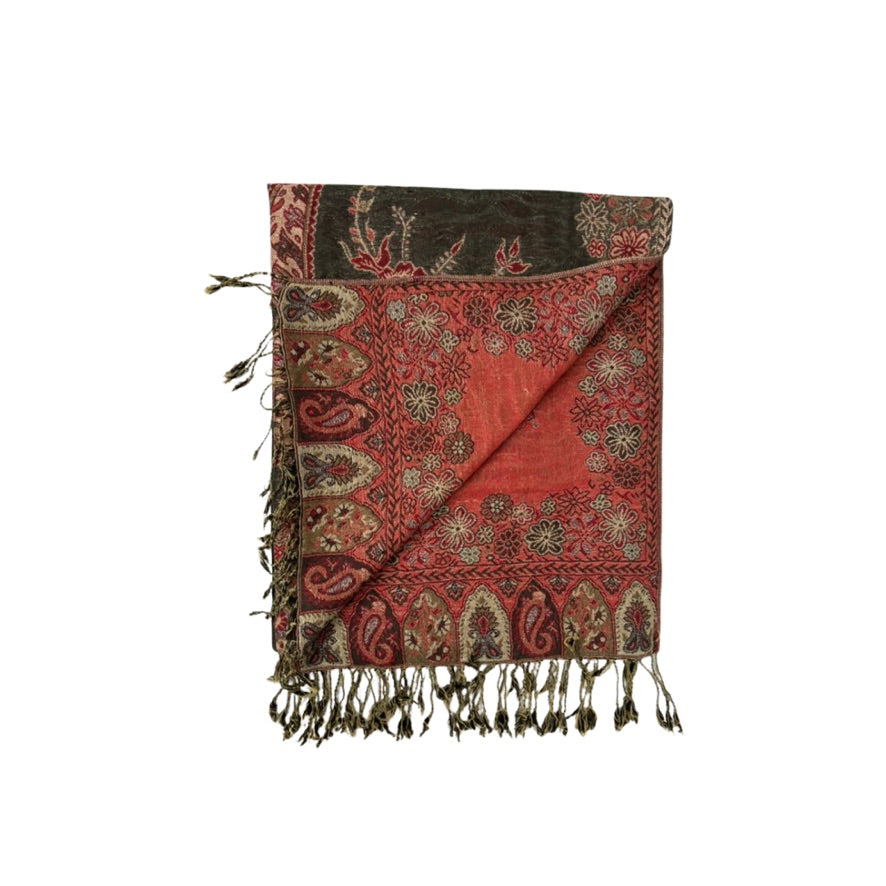 Folded red and brown patterned scarf with fringes on a white background