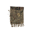 Decorative throw blanket with intricate patterns and fringes on a white background