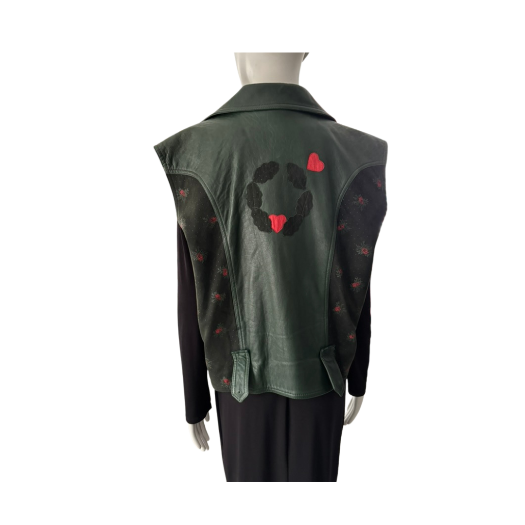 Green vest with black and red designs on a mannequin against a white background