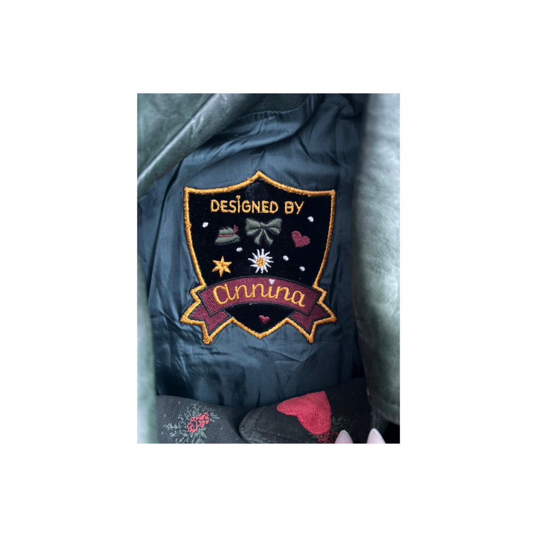 Patch on a jacket with 'Designed by Clinnia' text
