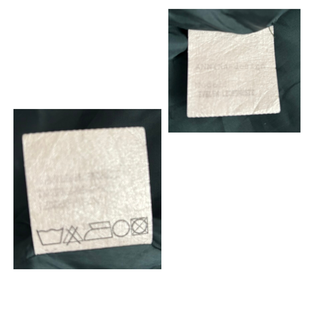 Three square labels with laundry symbols on a dark fabric background