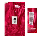 Pink floral shirt with size label and care instructions on a white background