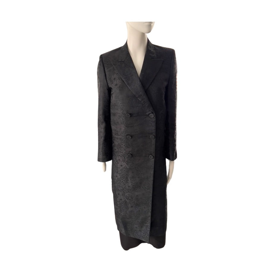 Long black coat on a mannequin against a white background