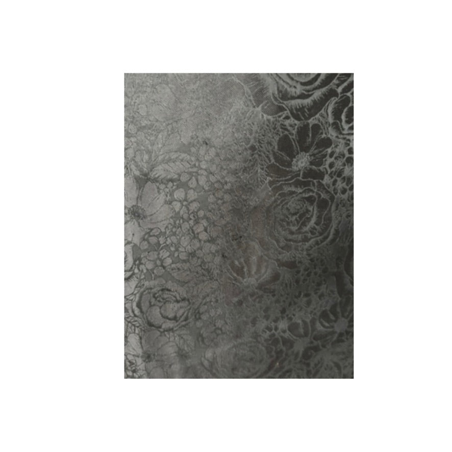 Textured black fabric with floral pattern on a white background