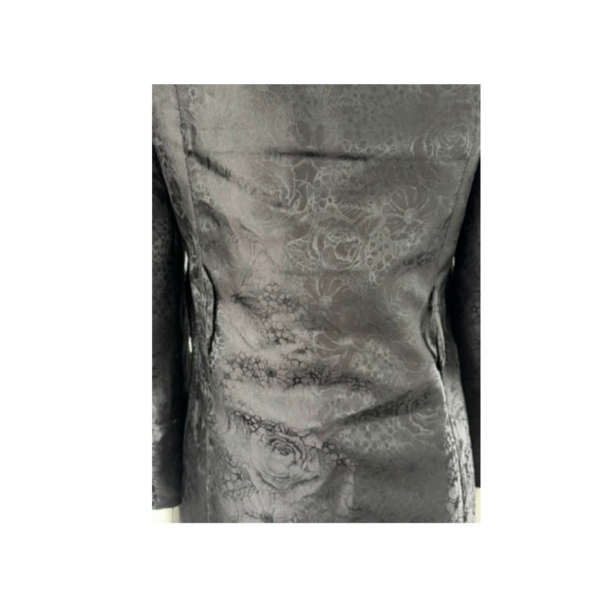 black textured fabric with floral patterns on a white background