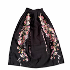 Black skirt with floral embroidery on a white background