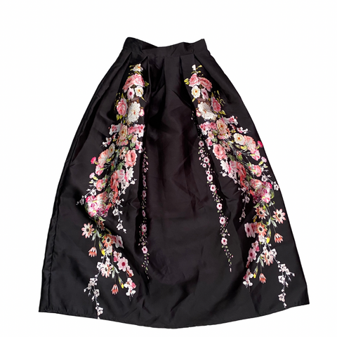 Black skirt with floral embroidery on a white background