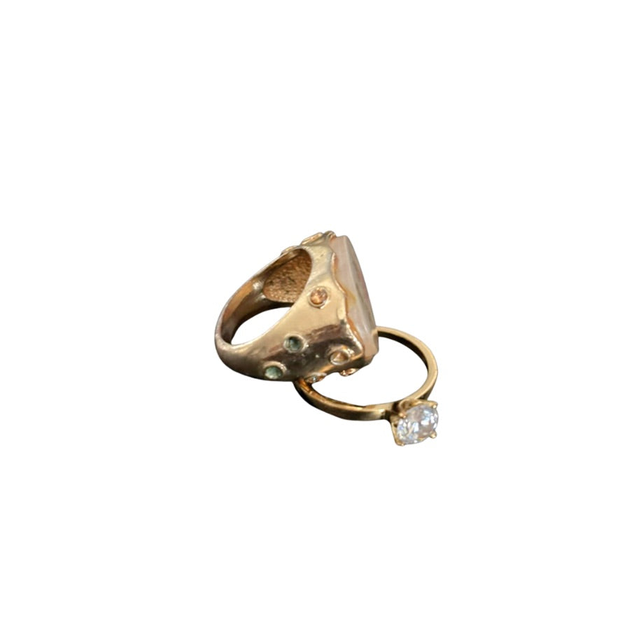 Gold ring with a diamond on a white background