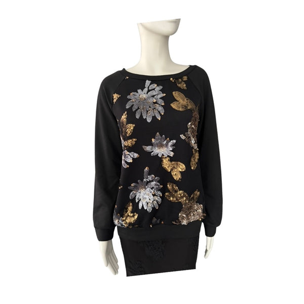 Black sweater with floral sequin patterns on a mannequin against a white background
