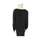 Black sweater on a mannequin against a white background