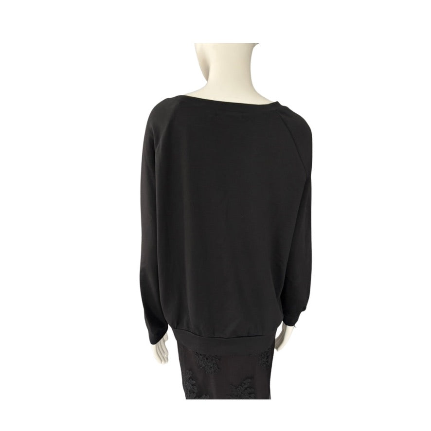 Black sweater on a mannequin against a white background