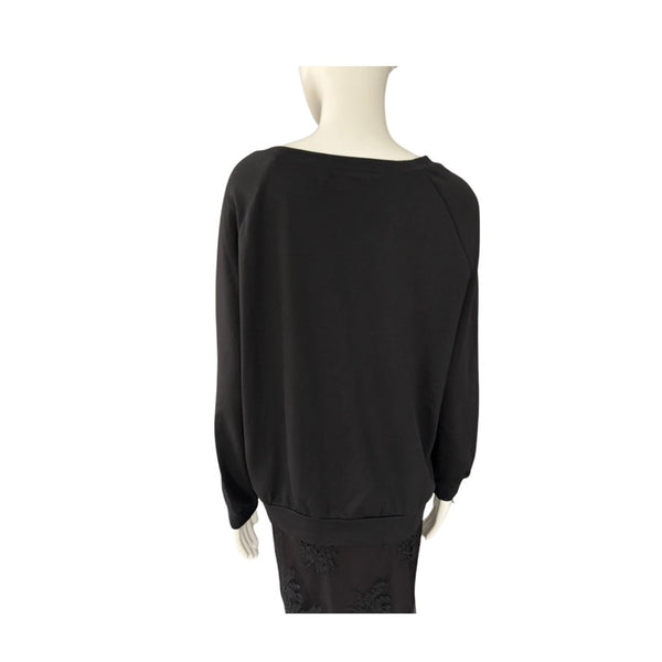 Black sweater on a mannequin against a white background