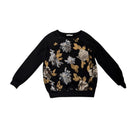 Black sweater with floral patterns on a white background