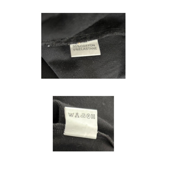 Close-up of fabric labels on a black garment with text and symbols.