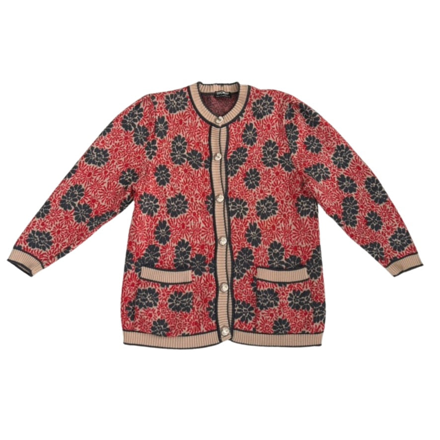 Red cardigan with navy floral pattern on a white background