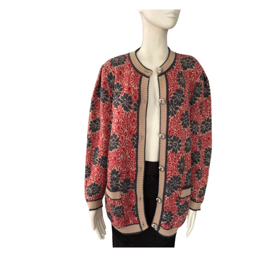 Mannequin wearing a red and black patterned cardigan on a white background