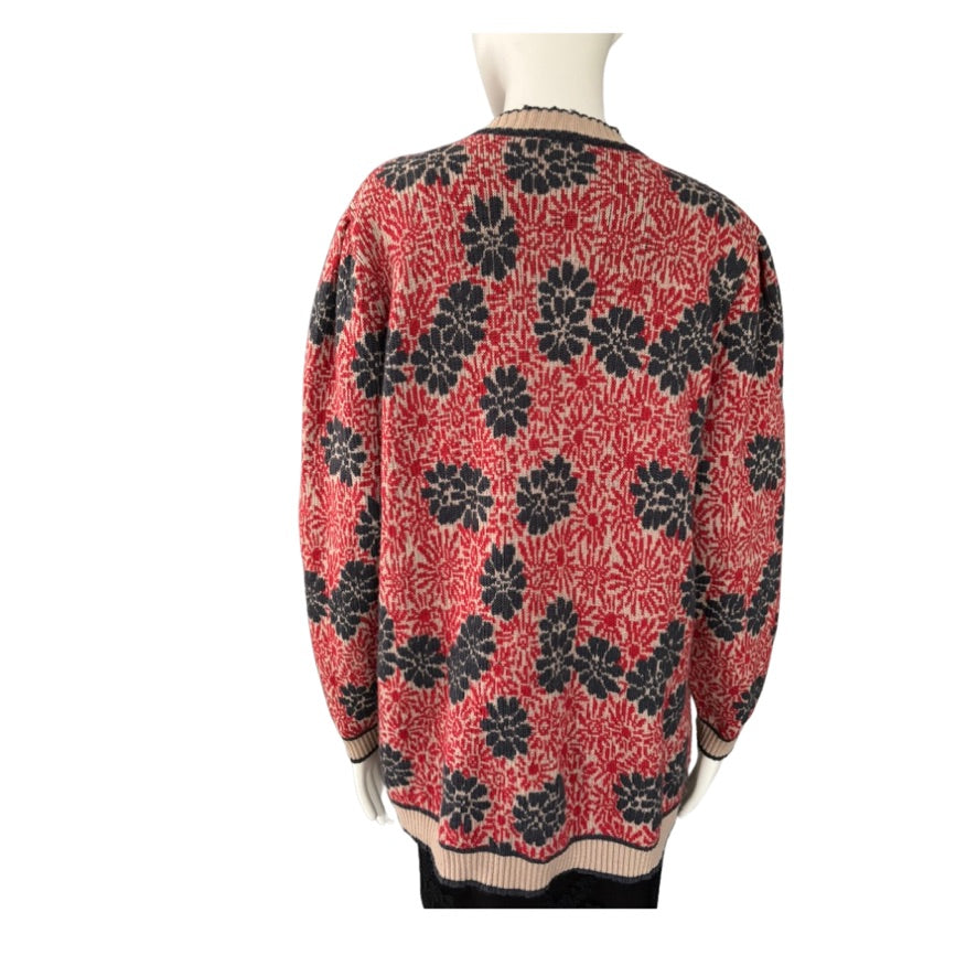 Red sweater with navy floral pattern on a mannequin against a white background