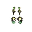 Pair of earrings with green gemstones on a white background