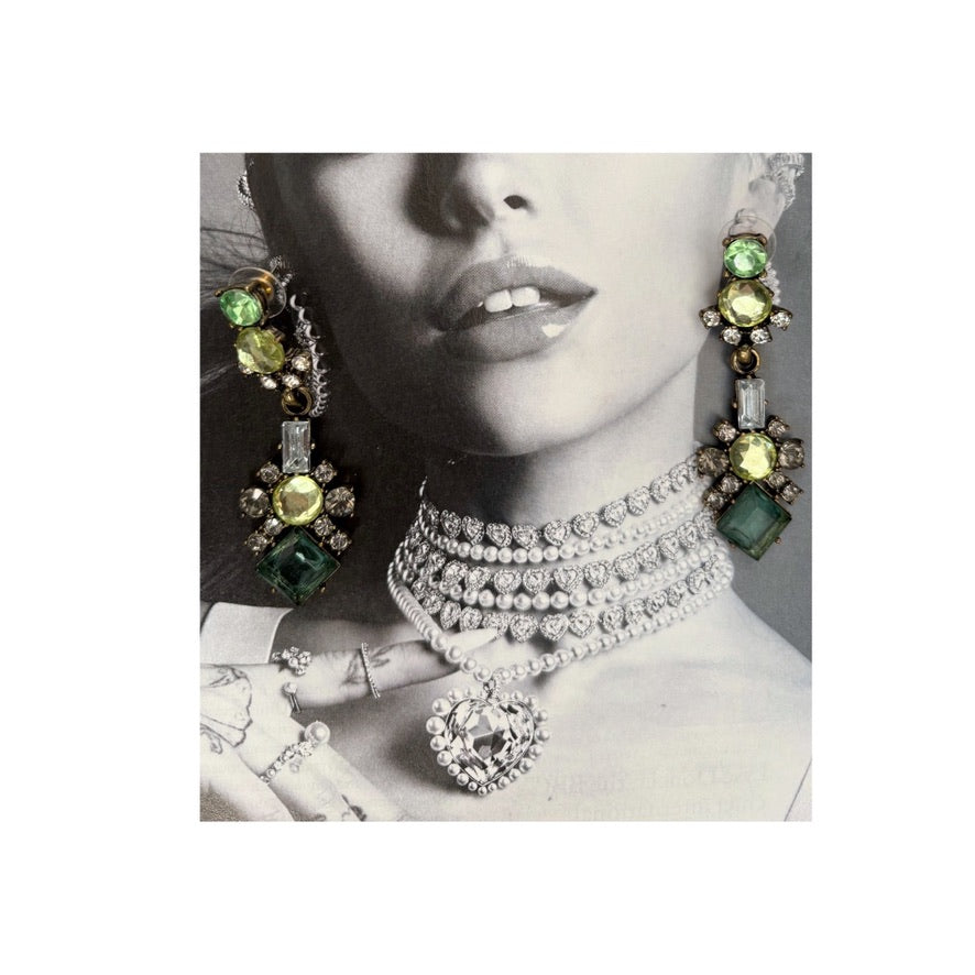 Jewelry set with green gemstone earrings and choker on a model against a black and white background